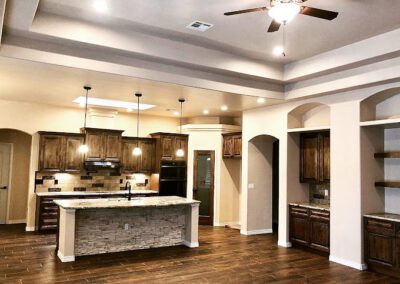 Open kitchen, custom cabinets, tile backsplash , wood look tile floor , ceiling treatments, recessed lighting and pendant lighting